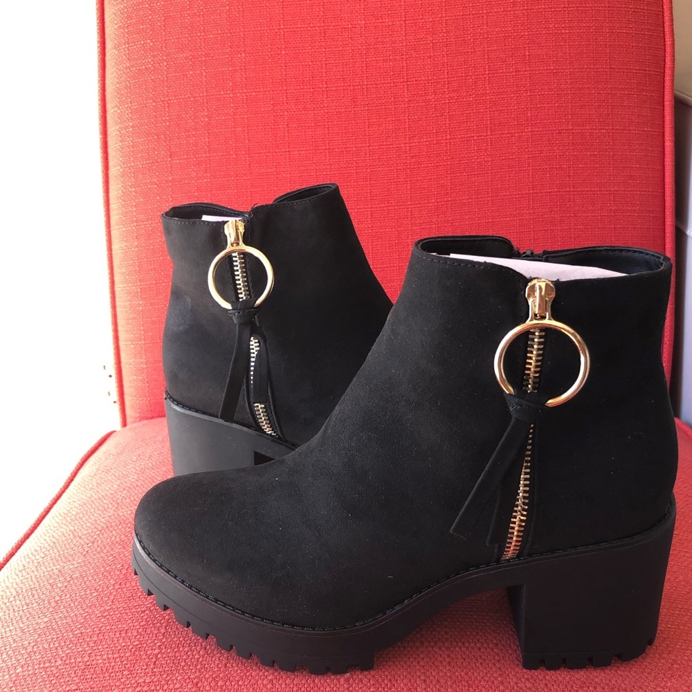 Black heeled booties with gold zipper